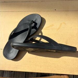 Olukai Black Flip Flop Sandals